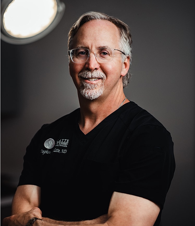 Portrait of a smiling doctor in scrubs.