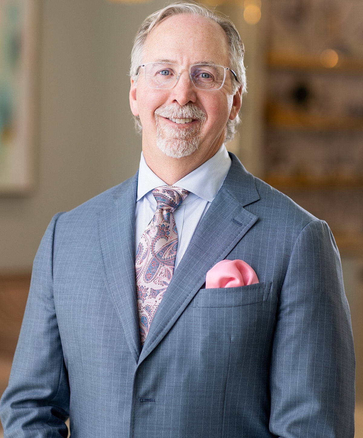 Male doctor smiling in professional attire.