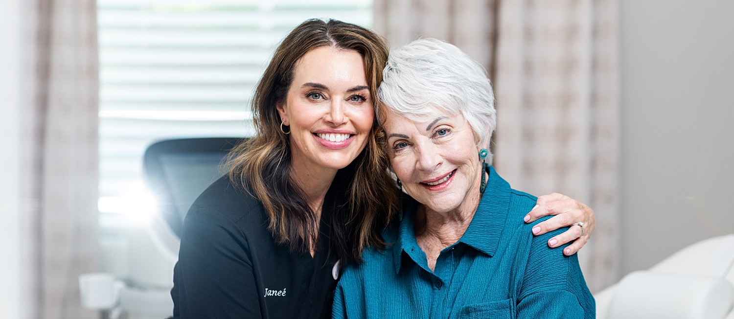 Model posing in black lingerie against white background.