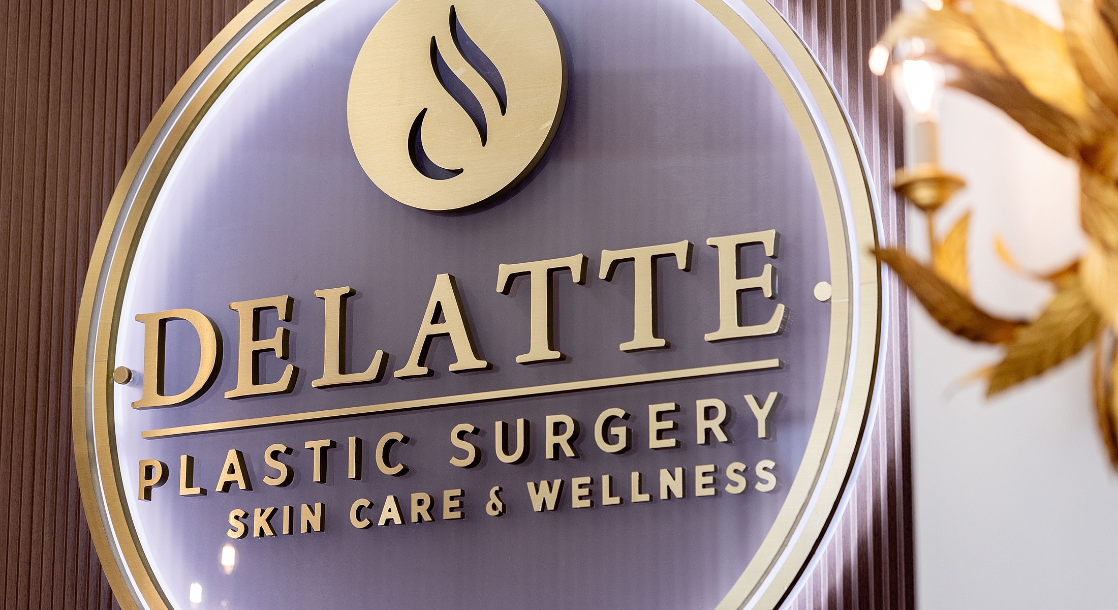 Delatte Plastic Surgery logo and sign.