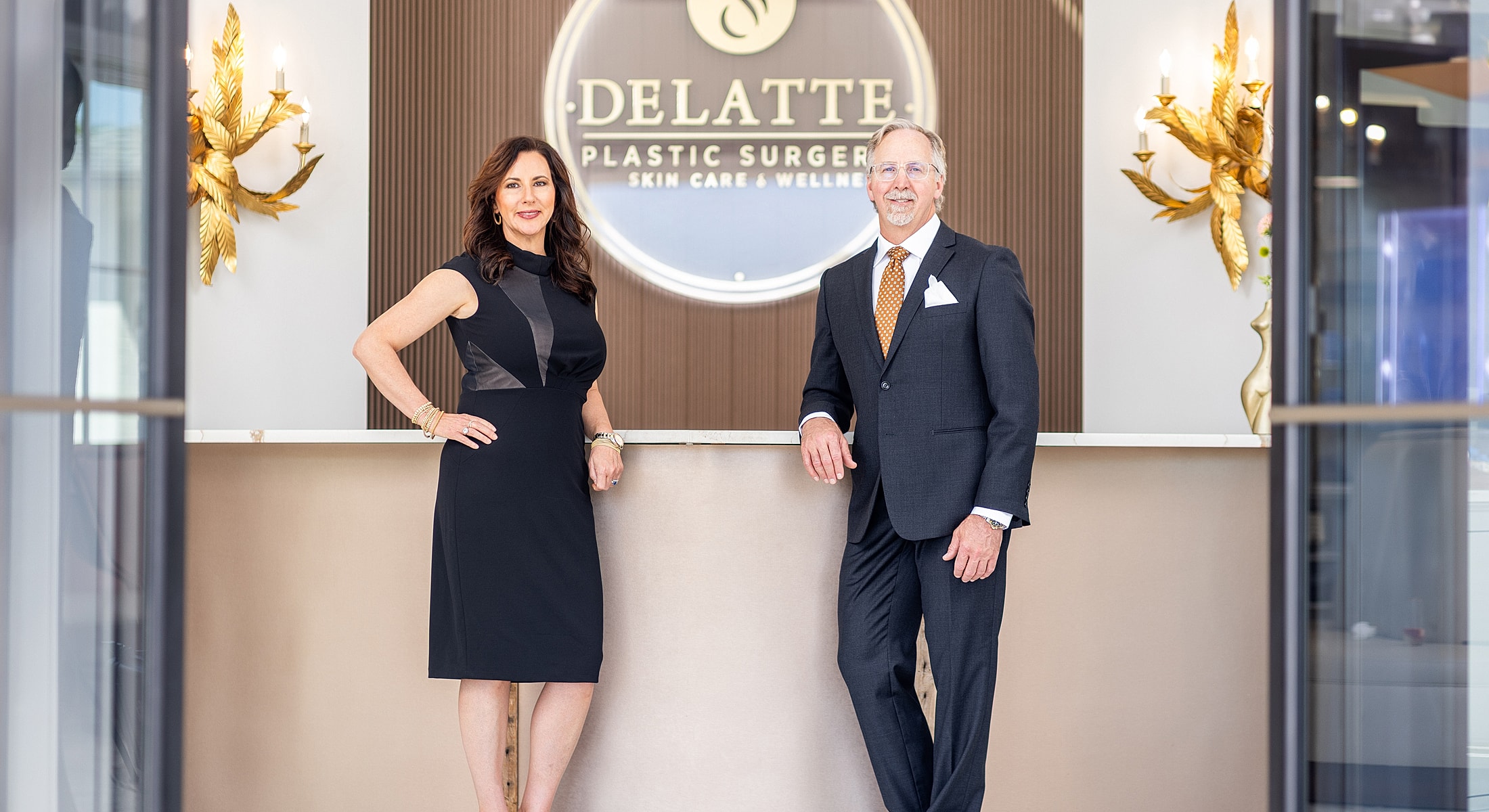 Plastic surgeons posing in a modern clinic.