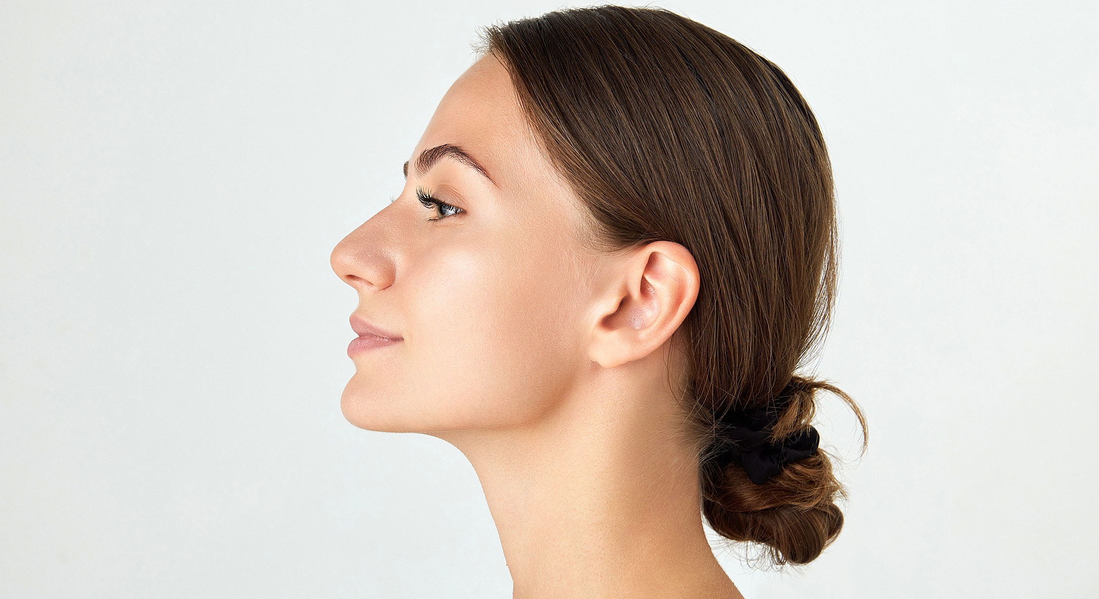 Profile view of a woman with a bun.