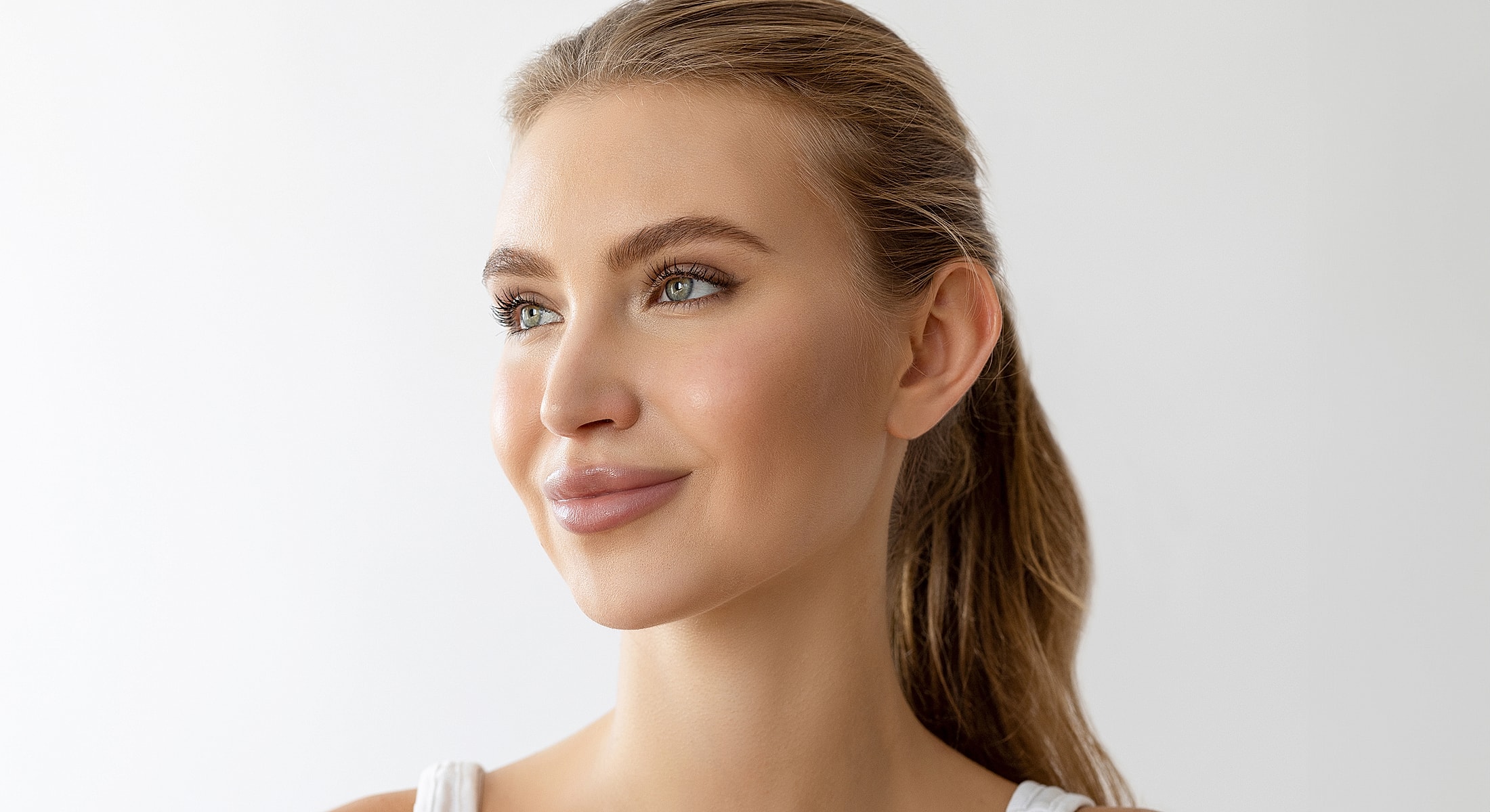 Man receiving cosmetic injection in clinic setting.