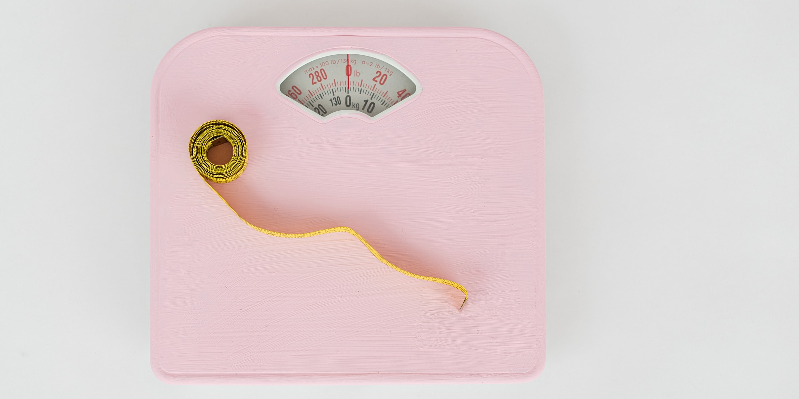 Vintage pink scale with measuring tape.