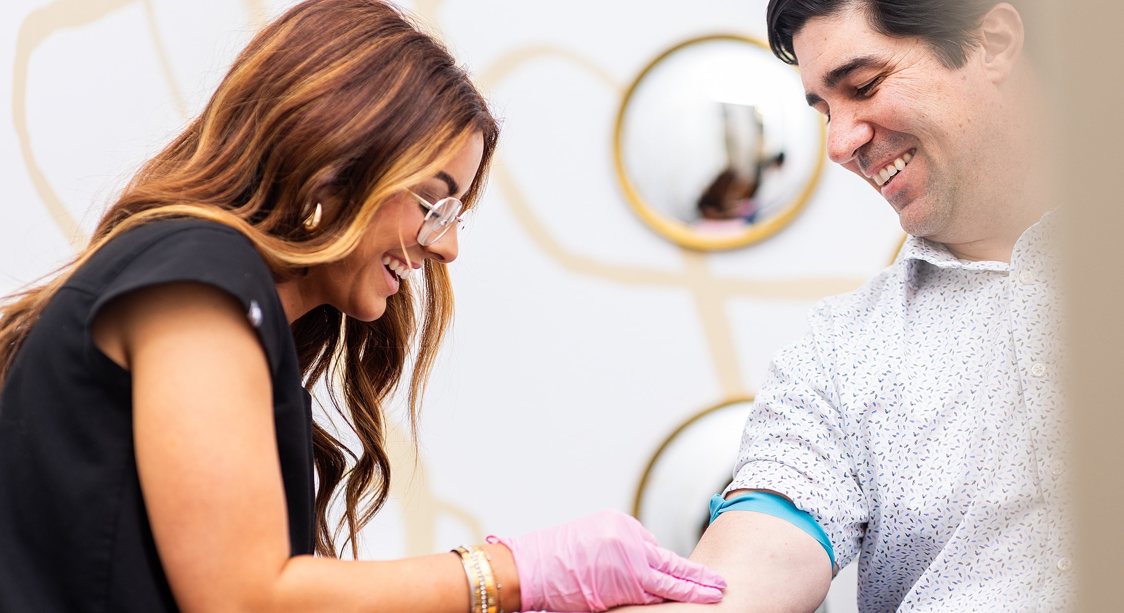 Nurse preparing to draw blood from patient.